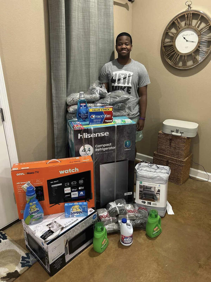 Dorm Essentials Scholarship 1 A senior receives a dorm essential scholarship, which includes items for college such as a bed, laundry supplies, a microwave and other dorm room items.